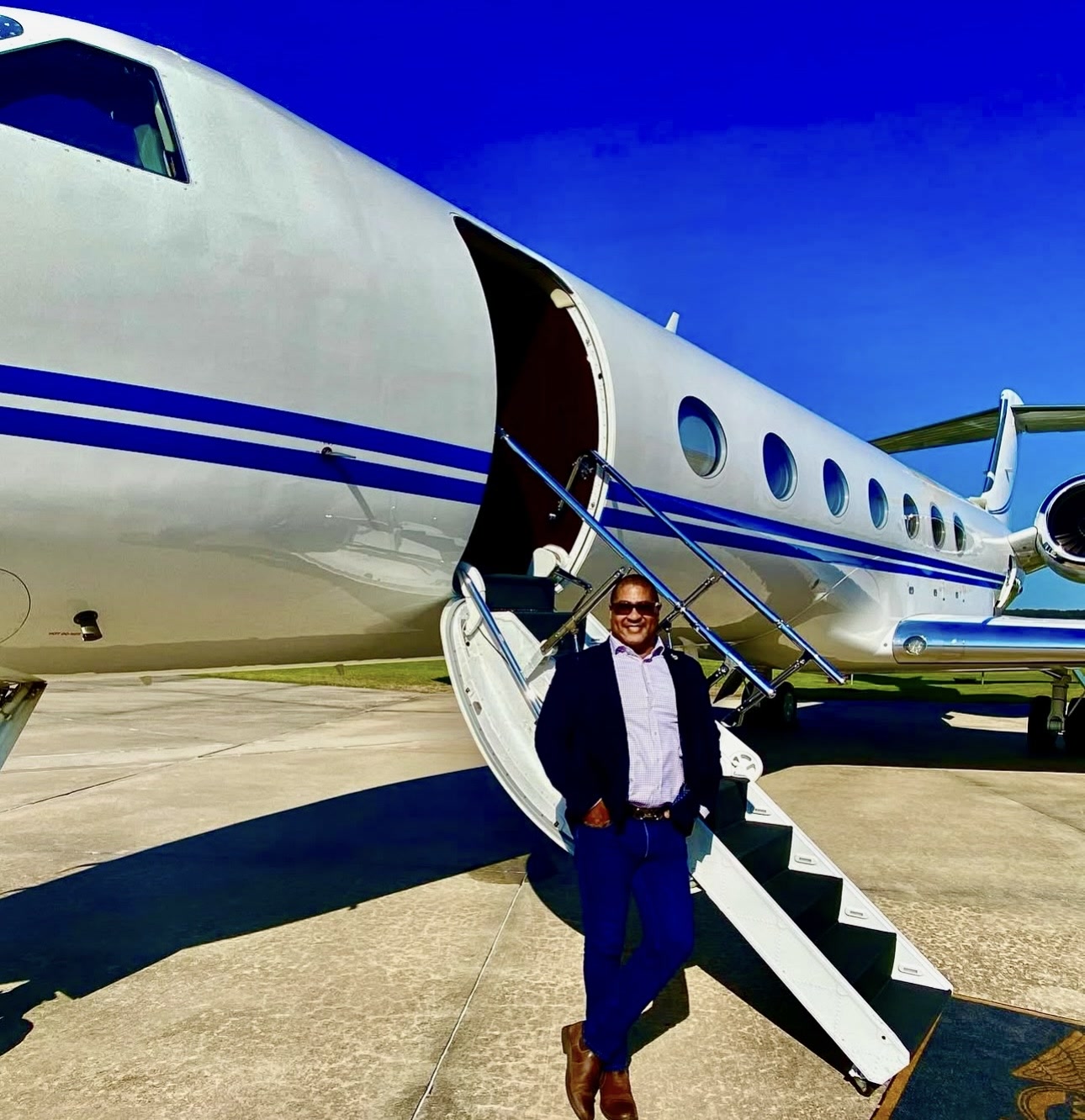 Kevin Lewis on the airstair of a private aircraft while travelling for work